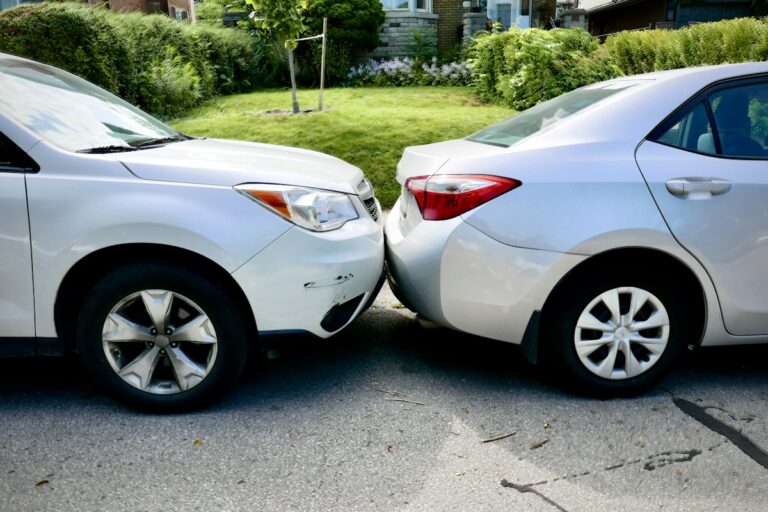 Two cars touching bumpers in a minor fender bender