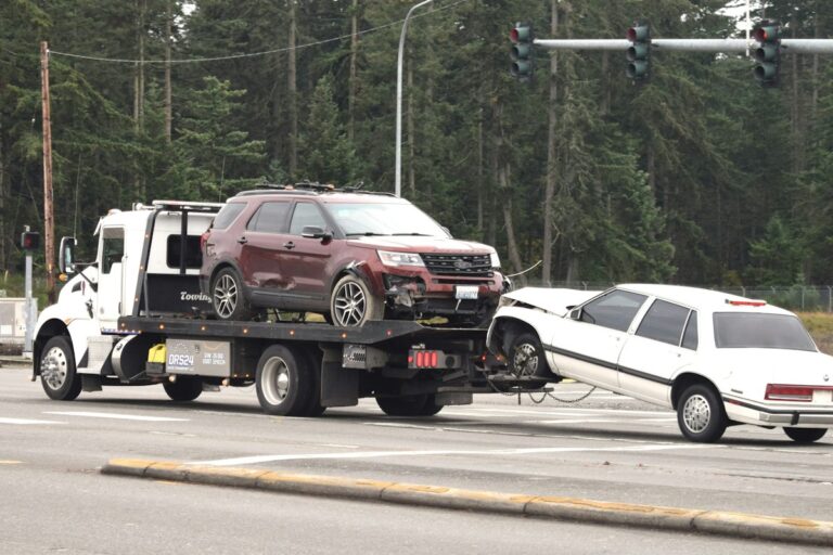 Flatbed tow truck carrying a car