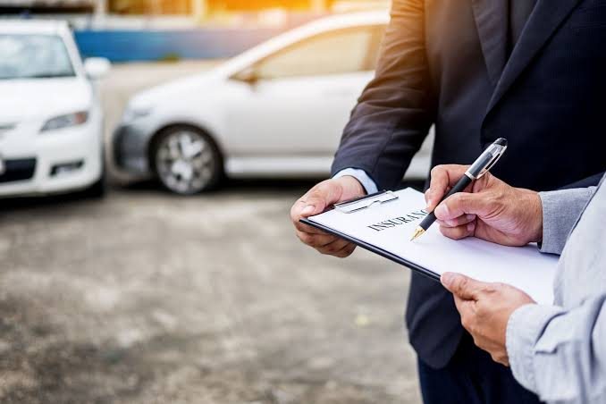 Agent reviewing an auto insurance policy with a client