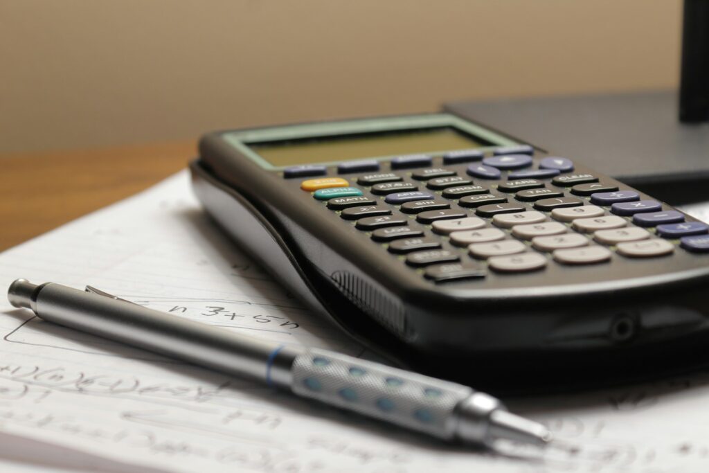 Calculator and pen resting on paperwork.