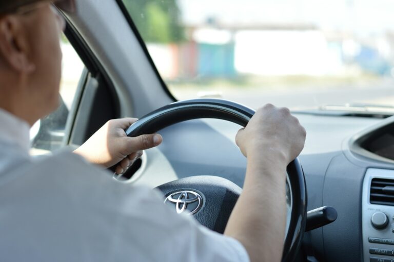 Driver holding the steering wheel with both hands.