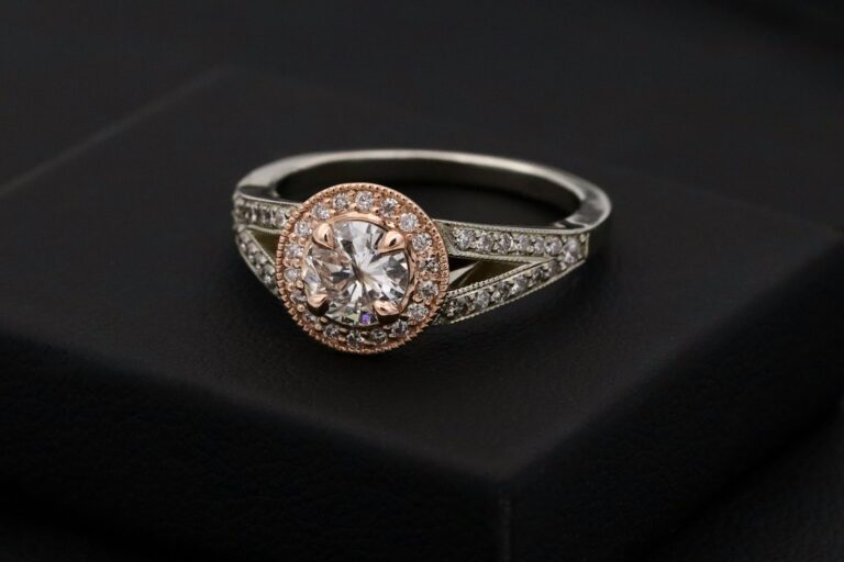 Gemstone ring displayed against dark fabric.
